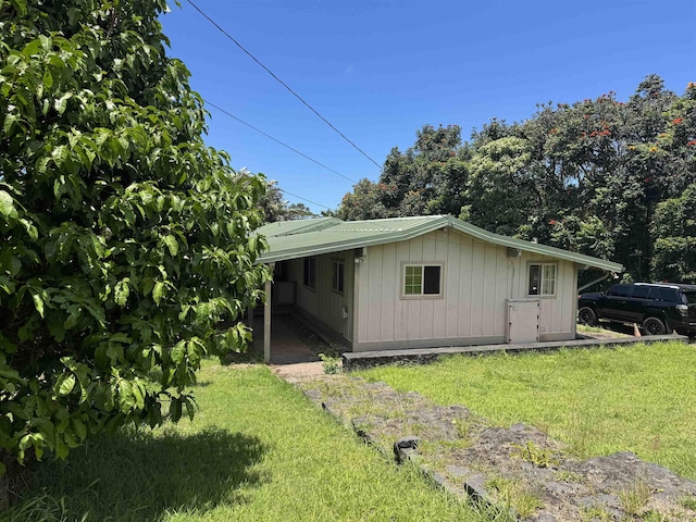 80 Alekanekelo Pl, Haiku, HI 96708 - view of side of home featuring a lawn and board and batten siding