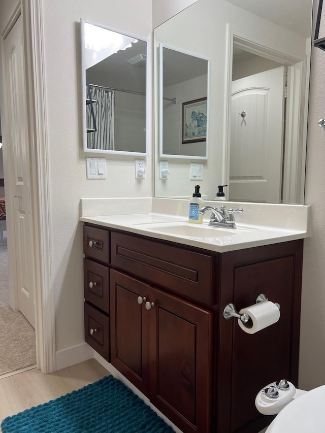 bathroom featuring vanity and hardwood / wood-style flooring