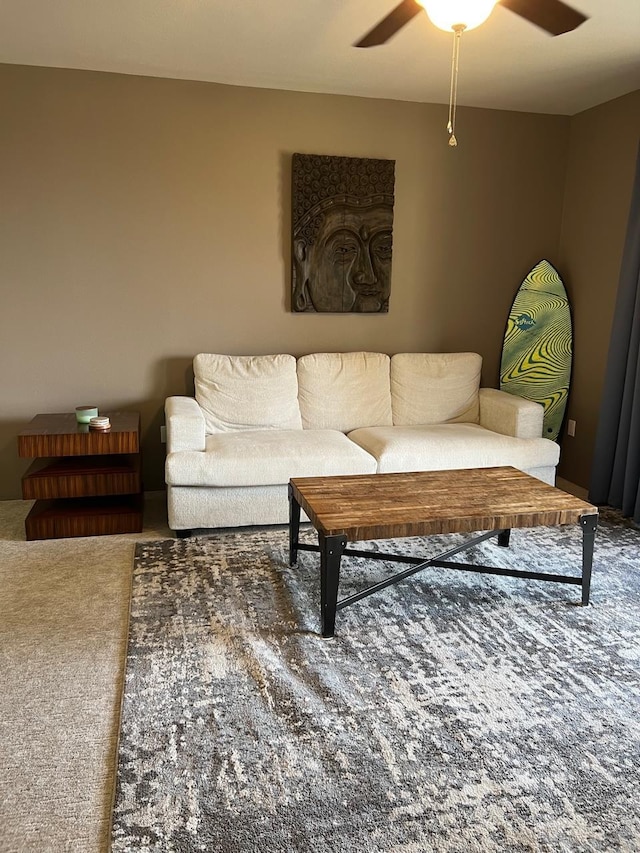 carpeted living room with ceiling fan