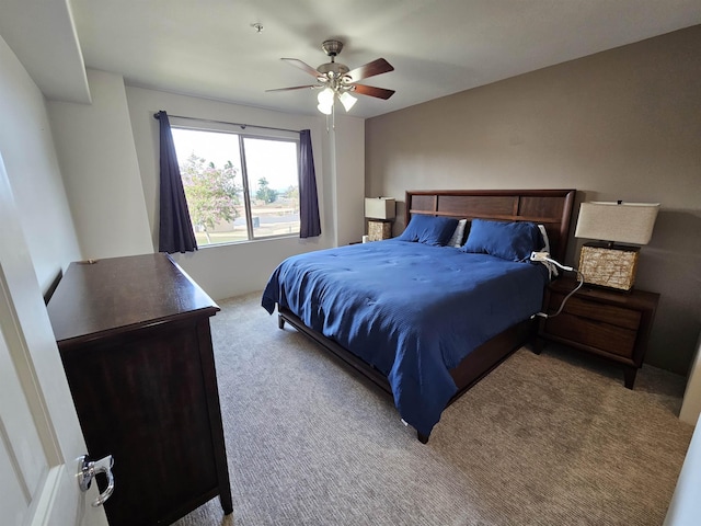 bedroom featuring light colored carpet and ceiling fan