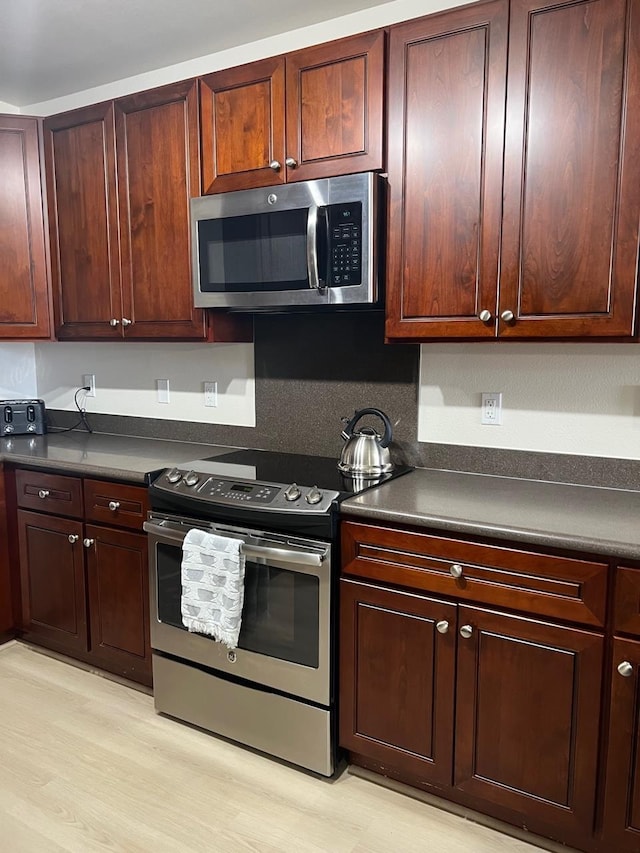 kitchen featuring stainless steel appliances and light wood-type flooring