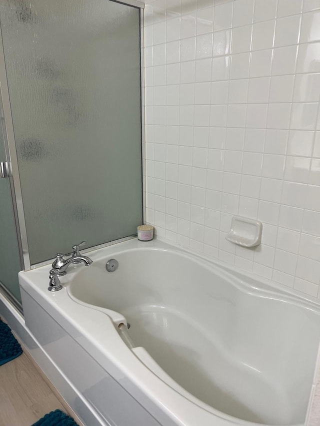 bathroom featuring hardwood / wood-style flooring and separate shower and tub