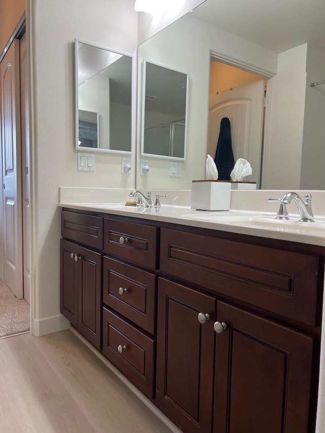 bathroom with vanity and hardwood / wood-style flooring