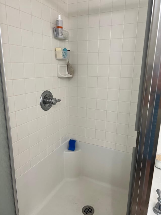 bathroom with a tile shower