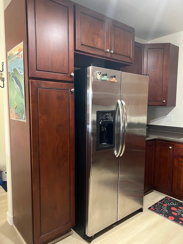 kitchen featuring stainless steel refrigerator with ice dispenser and light hardwood / wood-style flooring