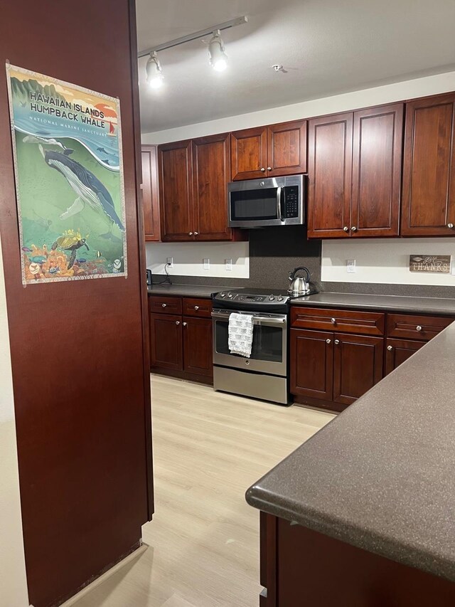 kitchen featuring light hardwood / wood-style flooring and appliances with stainless steel finishes