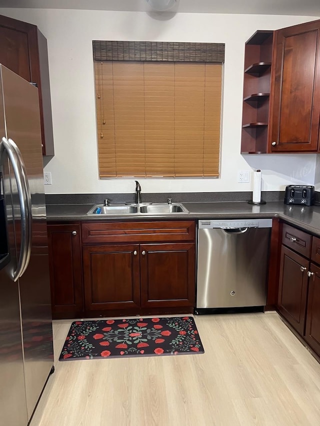 kitchen with light hardwood / wood-style floors, sink, and appliances with stainless steel finishes