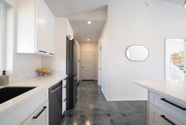 kitchen with light countertops, freestanding refrigerator, white cabinetry, and dishwasher