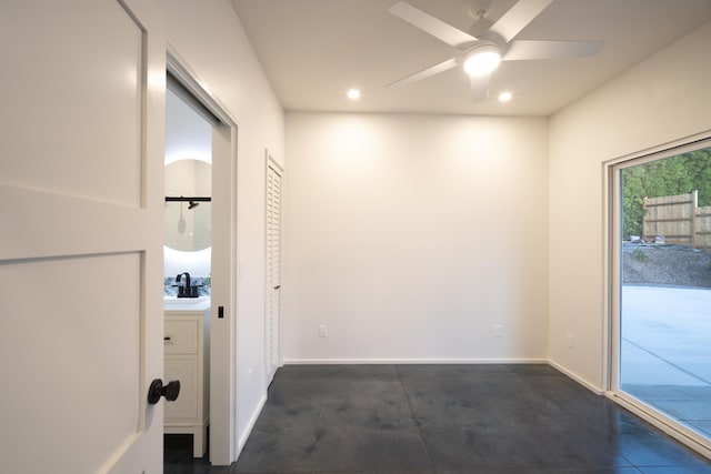 interior space with recessed lighting, a sink, and baseboards