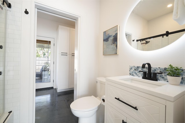 bathroom featuring toilet, a tile shower, and vanity