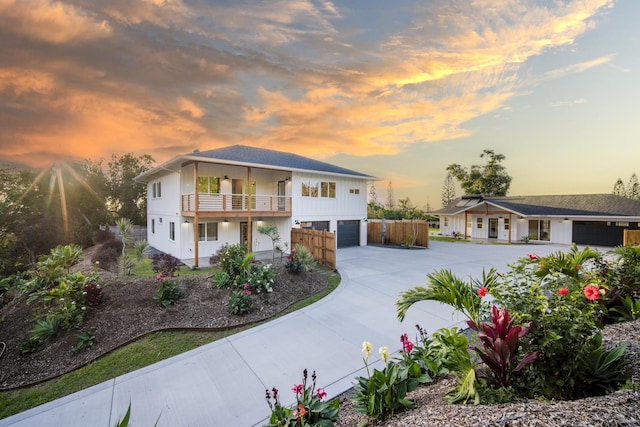 view of front of property featuring driveway, a balcony, and an attached garage