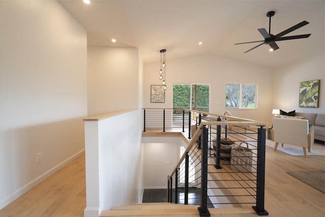 stairs with lofted ceiling, recessed lighting, baseboards, and wood finished floors