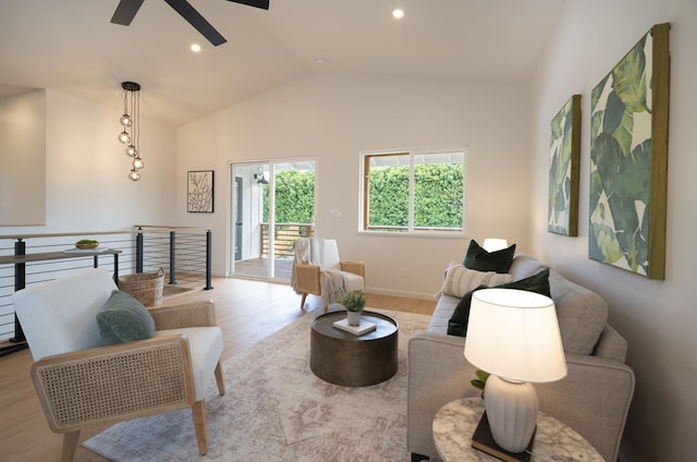 living room featuring lofted ceiling, baseboards, light wood-style flooring, and recessed lighting