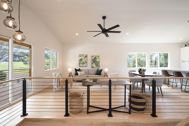 living area with light wood-style floors, lofted ceiling, and recessed lighting