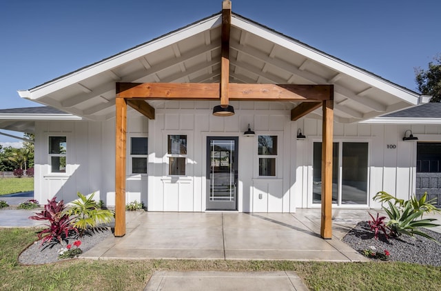 property entrance featuring board and batten siding