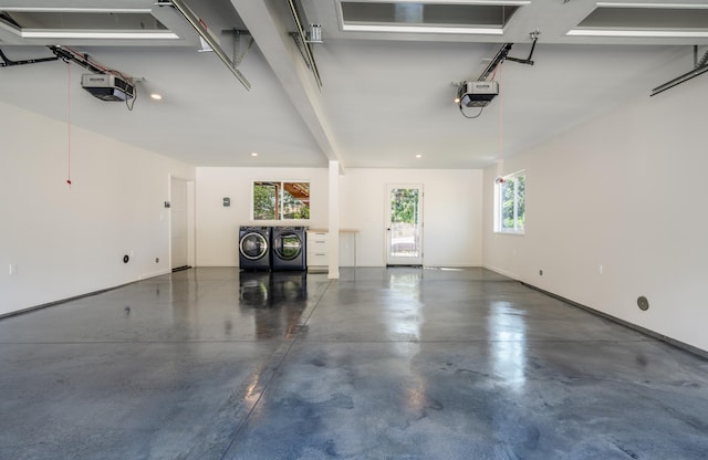 garage featuring a garage door opener and washer and dryer