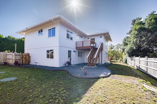 rear view of house with stairway, a patio area, a fenced backyard, and a lawn