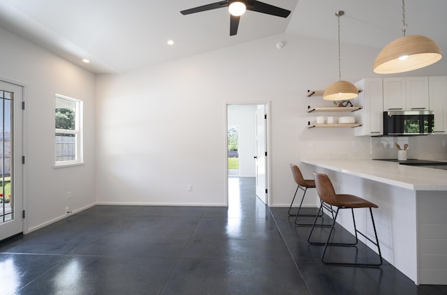 kitchen with decorative light fixtures, a peninsula, light countertops, white cabinetry, and open shelves