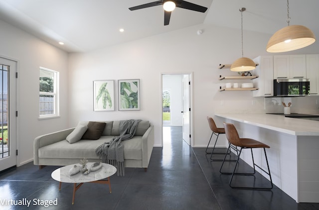 living area with plenty of natural light, baseboards, vaulted ceiling, and recessed lighting