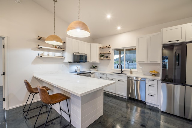 kitchen with a sink, white cabinets, hanging light fixtures, appliances with stainless steel finishes, and open shelves