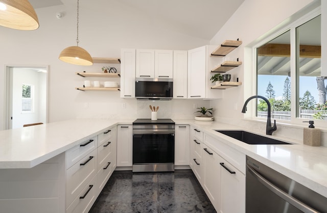 kitchen with stainless steel appliances, open shelves, hanging light fixtures, and a sink