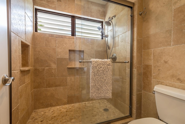 full bath with a stall shower and toilet