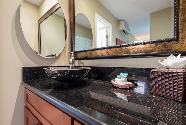 bathroom featuring an AC wall unit and vanity