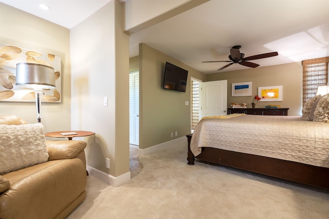 carpeted bedroom featuring ceiling fan and baseboards