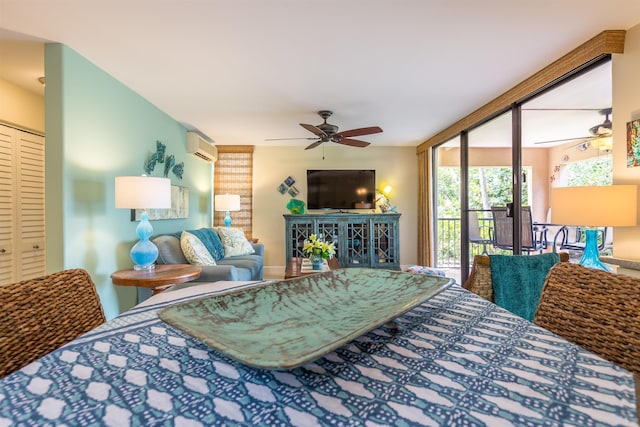 bedroom featuring a ceiling fan, access to outside, an AC wall unit, and expansive windows