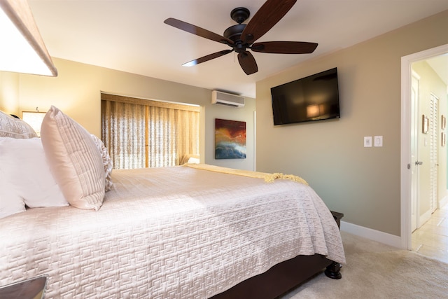 carpeted bedroom featuring ceiling fan, an AC wall unit, and baseboards