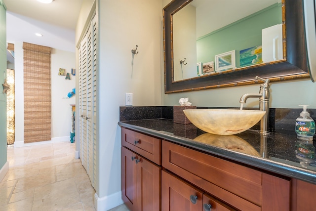 bathroom featuring recessed lighting, vanity, and baseboards