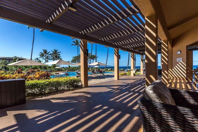 view of patio featuring a community pool and a pergola