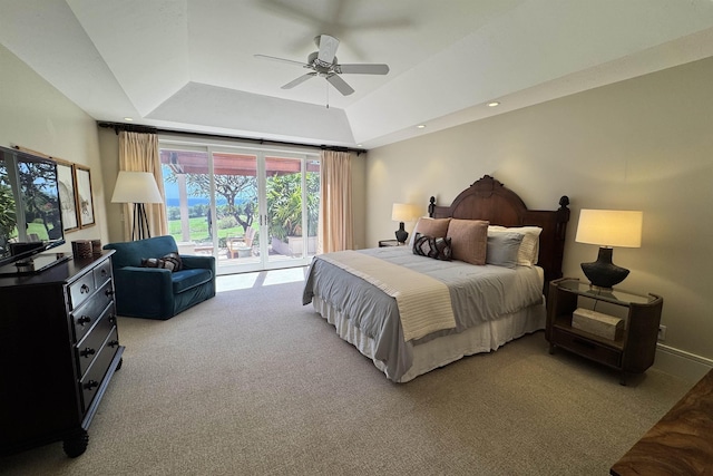 bedroom with a ceiling fan, a tray ceiling, recessed lighting, access to exterior, and light carpet