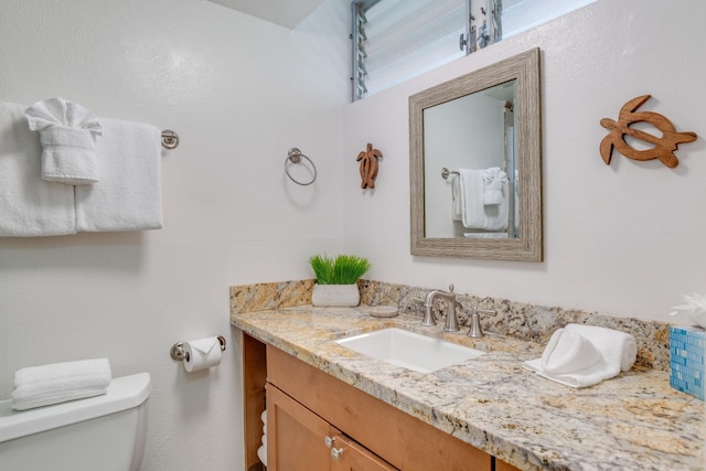 bathroom with toilet and vanity