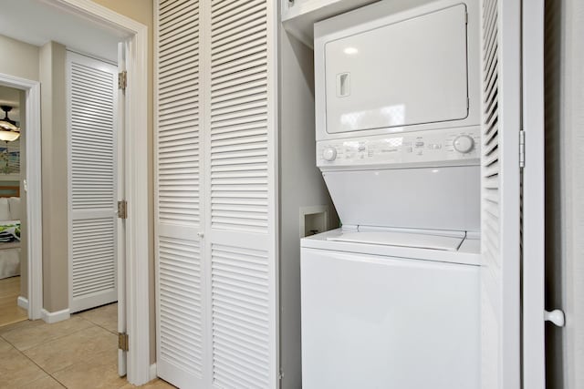 3300 Wailea Alanui Dr Unit 52D, Kihei, HI 96753 - laundry area featuring stacked washer / drying machine, light tile patterned floors, and baseboards