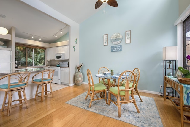 3300 Wailea Alanui Dr Unit 52D, Kihei, HI 96753 - dining room with plenty of natural light, track lighting, a ceiling fan, vaulted ceiling, and light wood-style flooring