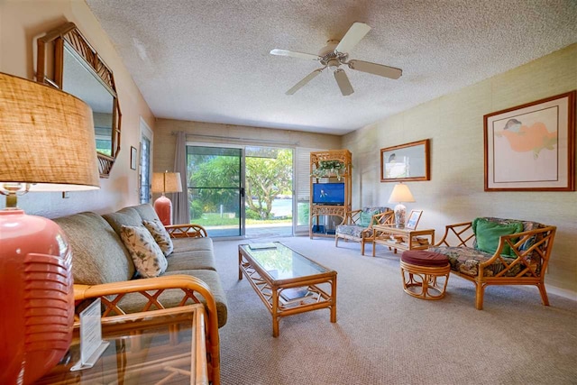 living room with carpet flooring, a textured ceiling, and a ceiling fan