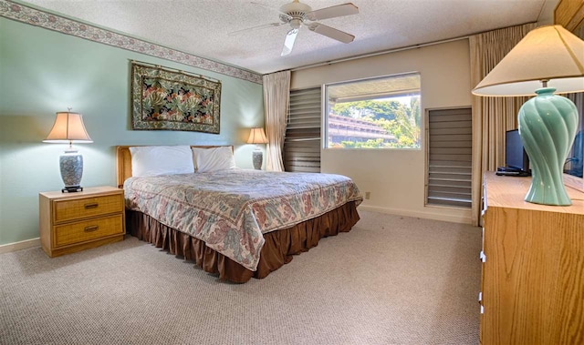 bedroom featuring carpet flooring, ceiling fan, a textured ceiling, and baseboards