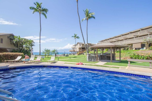 community pool with a gazebo, a yard, and a patio