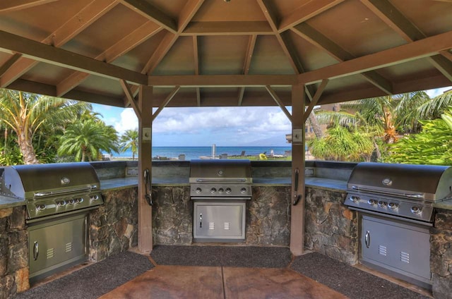 view of patio featuring a gazebo, grilling area, and exterior kitchen