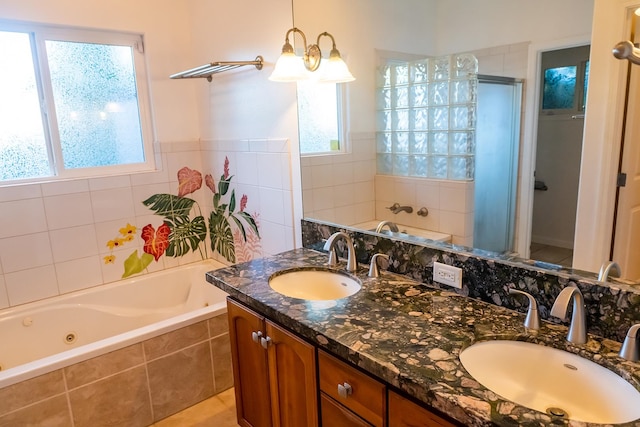 bathroom featuring dual vanity, tile flooring, and a relaxing tiled bath