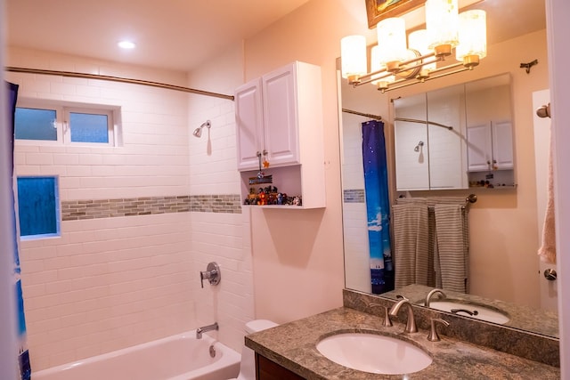 full bathroom with toilet, shower / bath combo, a notable chandelier, and vanity