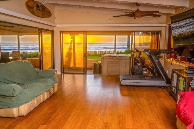 sunroom featuring ceiling fan and beam ceiling