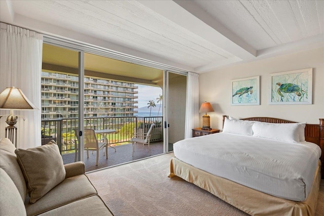 carpeted bedroom featuring beamed ceiling and access to outside