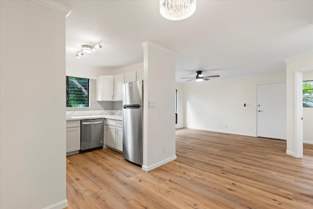 kitchen featuring light hardwood / wood-style floors, ceiling fan, stainless steel appliances, and white cabinets