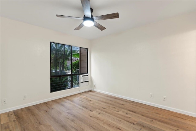 spare room with ceiling fan, cooling unit, and light hardwood / wood-style flooring