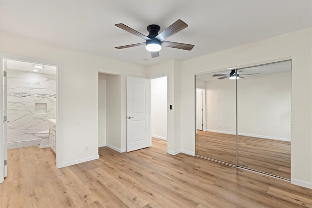 unfurnished bedroom featuring light wood-type flooring, ceiling fan, ensuite bathroom, and a closet