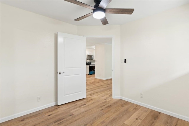 empty room featuring ceiling fan and light hardwood / wood-style floors