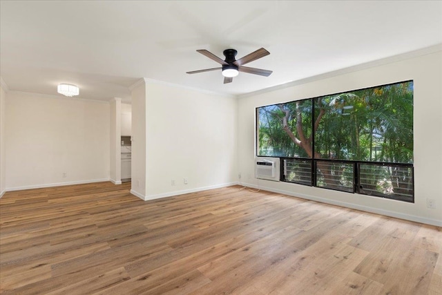 spare room with ornamental molding, light wood-type flooring, and ceiling fan