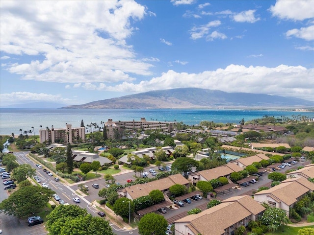 birds eye view of property with a water and mountain view